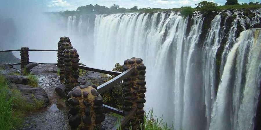 Victoria Falls Guided Tour Zimbabwe & Zambia From Both Sides - Walking across Victoria Falls Bridge